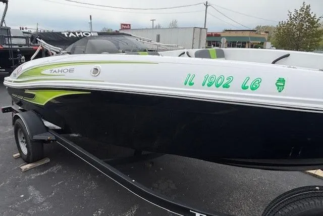 Slide: The Image of 2024 Tahoe T18 boat on trailer, featuring sleek design and green accents. - 36