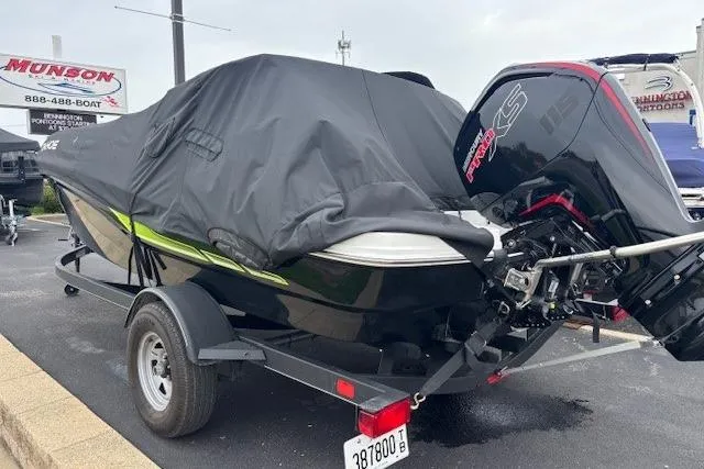 Slide: The Image of 2024 Tahoe T18 boat on trailer, covered, with powerful outboard motor. - 38