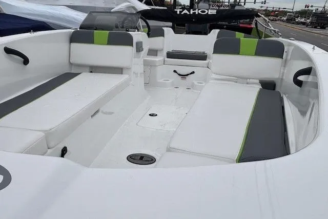 Slide: The Image of 2024 Tahoe T18 boat interior with white and green seating, spacious layout. - 4