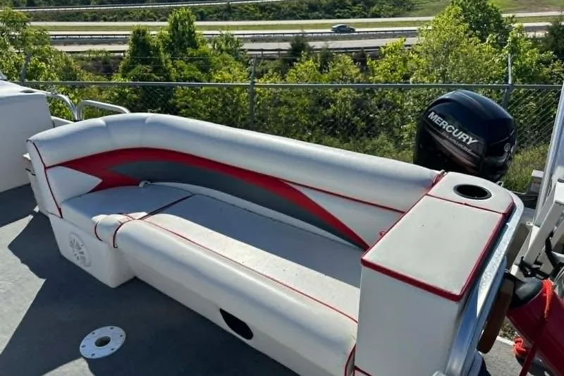 Slide: The Image of 1999 PlayCraft Sport 2400 boat with cushioned seating and Mercury outboard motor. - 11