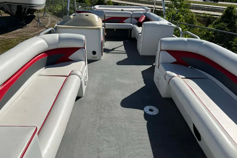 Slide: The Image of 1999 PlayCraft Sport 2400 pontoon boat interior with red and white seating. - 12