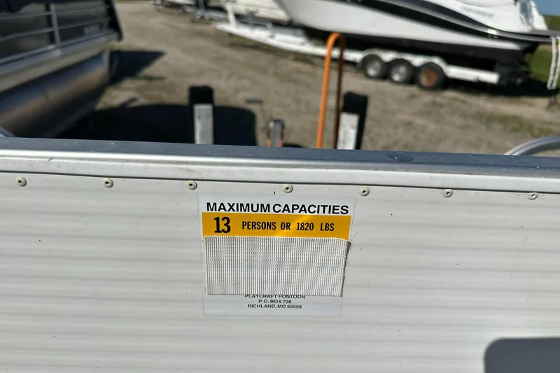 Slide: The Image of 1999 PlayCraft Sport 2400 boat capacity label, maximum 13 persons or 1820 lbs. - 6