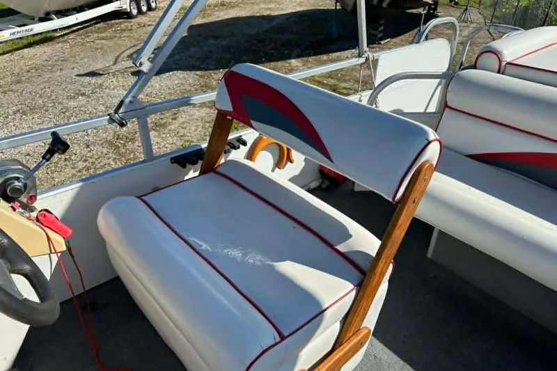 Slide: The Image of 1999 PlayCraft Sport 2400 boat interior with white and red seating. - 7