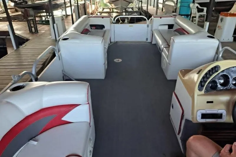 Slide: The Image of 1999 PlayCraft Sport 2400 pontoon boat interior with white and red seating. - 8