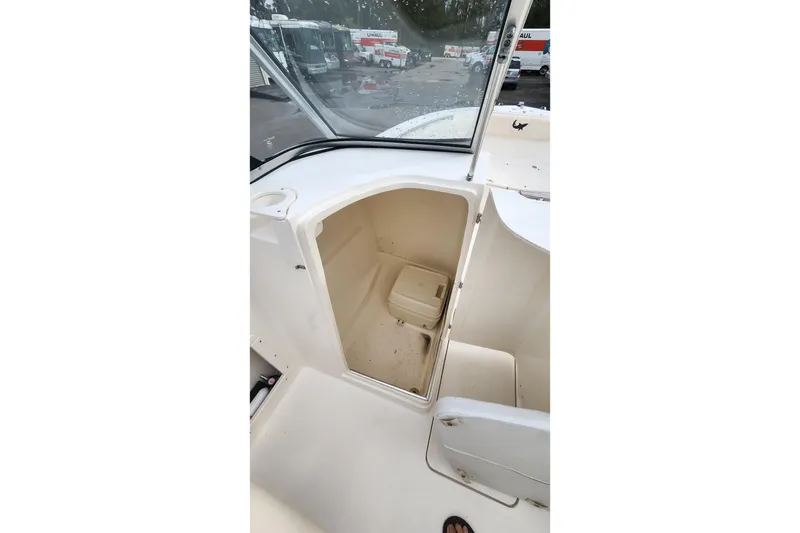 Slide: The Image of 2006 Mako 216 Dual Console boat interior with storage compartment open. - 18