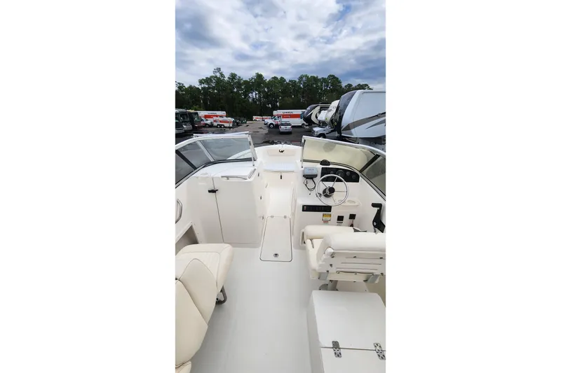 Slide: The Image of 2006 Mako 216 Dual Console boat interior with steering wheel and seating. - 19