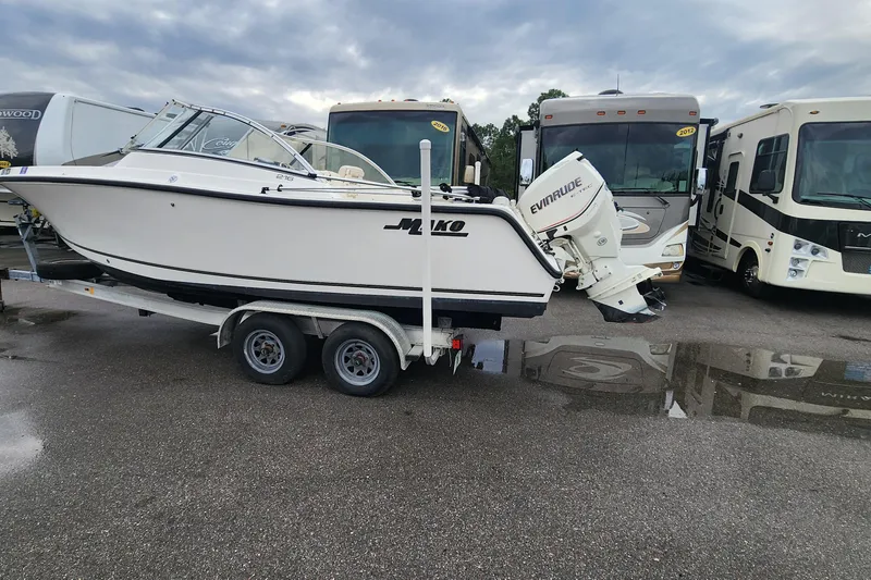 Slide: The Image of 2006 Mako 216 Dual Console boat on trailer, parked near RVs. - 4