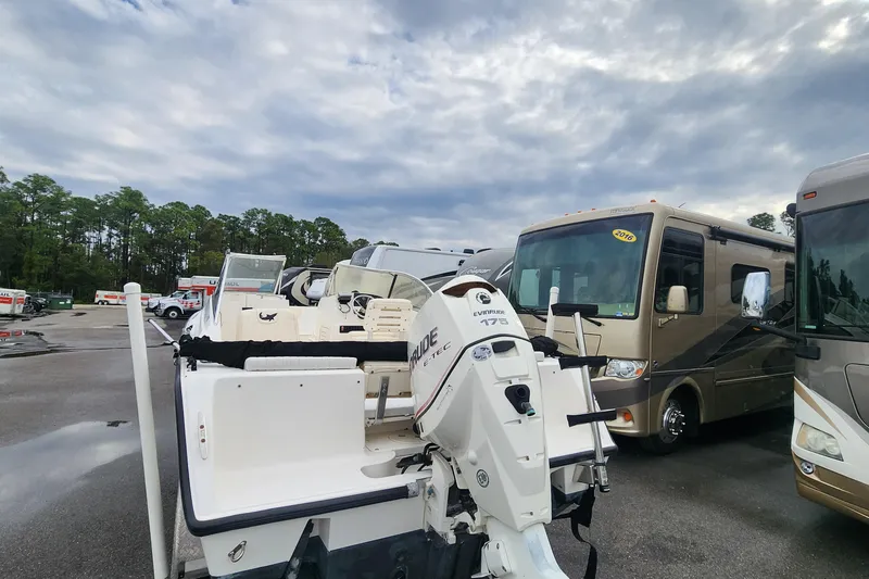 Slide: The Image of 2006 Mako 216 Dual Console boat with Evinrude 175 engine in parking lot. - 7
