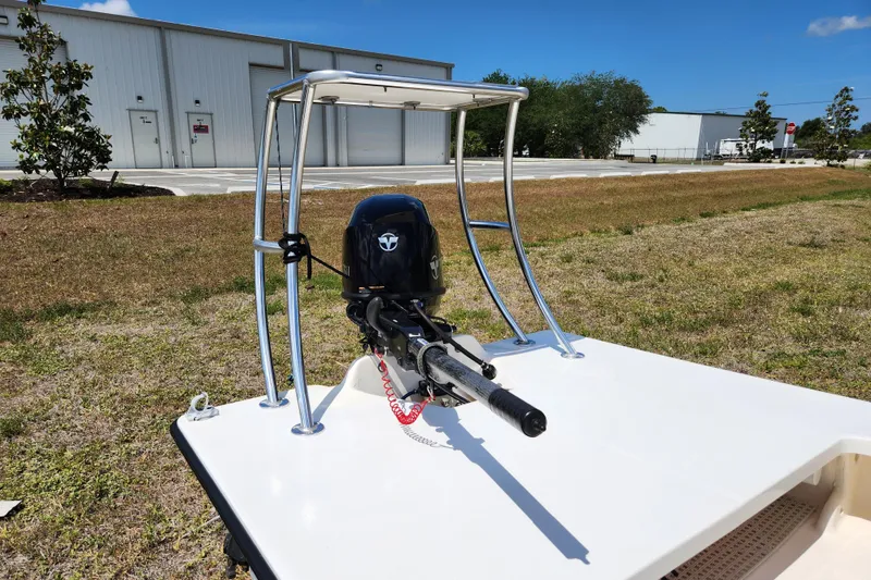 Slide: The Image of 2020 Spear Boatworks Evergladez with motor, parked outdoors near industrial buildings. - 13