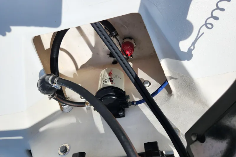 Slide: The Image of 2020 Spear Boatworks Evergladez engine compartment with hoses and fuel filter. - 16