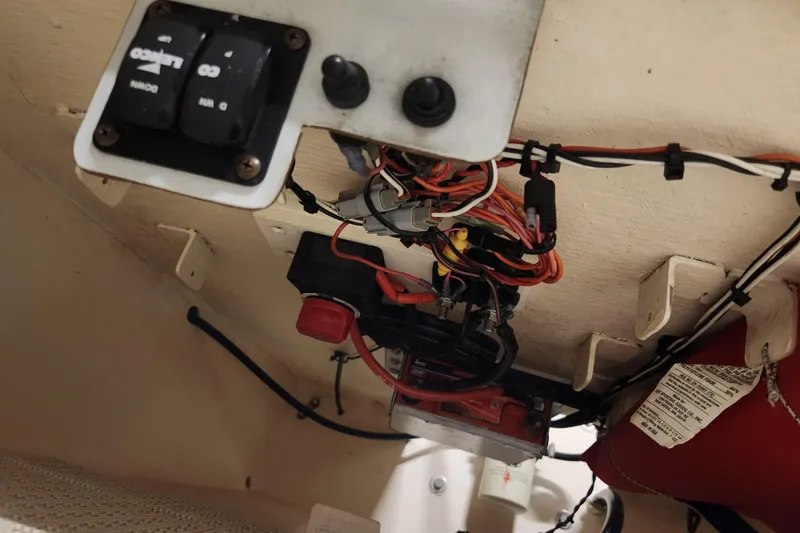Slide: The Image of Electrical wiring and switches inside a 2020 Spear Boatworks Evergladez boat. - 24