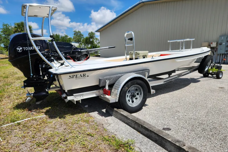 Slide: The Image of 2020 Spear Boatworks Evergladez on trailer, featuring Tohatsu outboard motor, parked outdoors. - 4