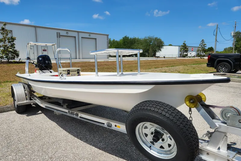 Slide: The Image of 2020 Spear Boatworks Evergladez on trailer, parked outdoors under clear blue sky. - 5