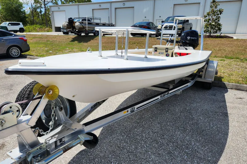 Slide: The Image of 2020 Spear Boatworks Evergladez on trailer, parked outdoors near industrial buildings. - 6