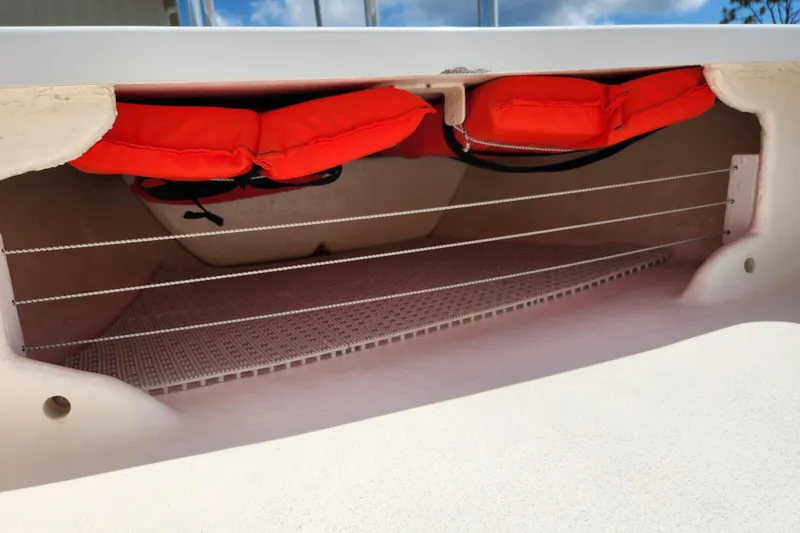Slide: The Image of Storage compartment of 2020 Spear Boatworks Evergladez with red life jackets. - 9