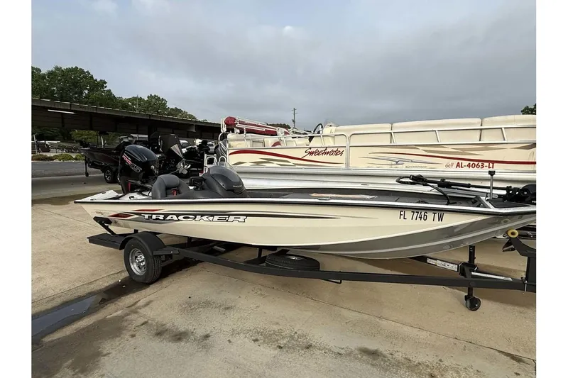 The Image of 2024 Tracker Pro Team 190 TX boat on trailer, parked outdoors. - 0