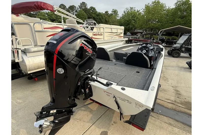 Slide: The Image of 2024 Tracker Pro Team 190 TX boat with Mercury Pro XS engine, parked outdoors. - 2