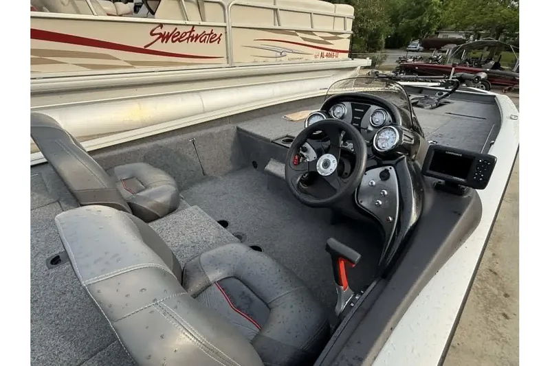 Slide: The Image of 2024 Tracker Pro Team 190 TX boat interior with steering console and seating. - 3