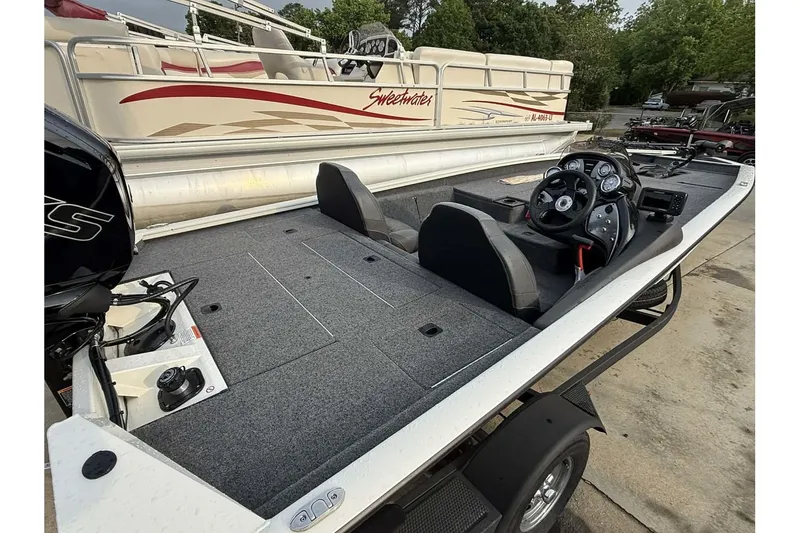 Slide: The Image of 2024 Tracker Pro Team 190 TX fishing boat with dual seats and steering console. - 4