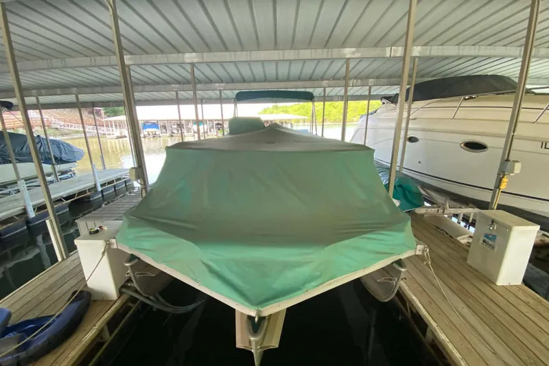 Slide: The Image of Covered 1995 PlayCraft Powertoon 26 boat docked in a marina. - 17