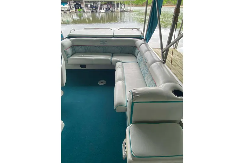 Slide: The Image of 1995 PlayCraft Powertoon 26 interior with plush seating, teal accents, and waterfront view. - 18