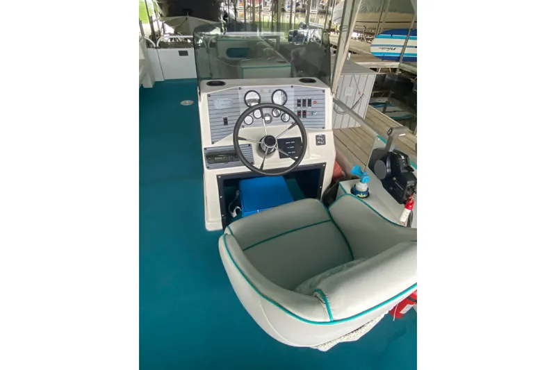 Slide: The Image of 1995 PlayCraft Powertoon 26 boat helm with steering wheel and control panel. - 3