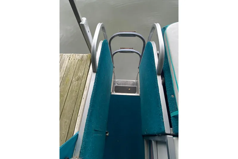 Slide: The Image of Boarding ladder on a 1995 PlayCraft Powertoon 26 pontoon boat by the dock. - 6