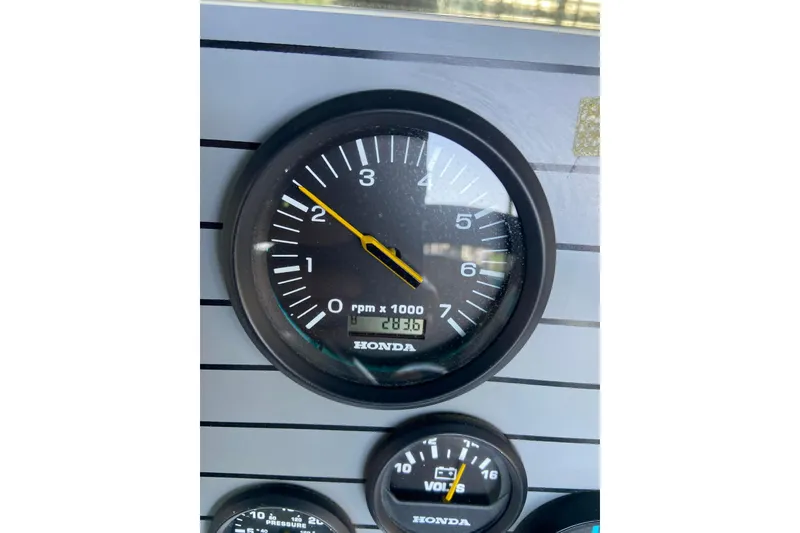 Slide: The Image of Close-up of Honda tachometer on 1995 PlayCraft Powertoon 26 boat dashboard. - 7
