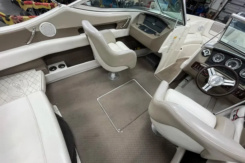 Slide: The Image of Interior of a 2012 Sea Ray SLX 230 boat, featuring plush seating and modern dashboard. - 12