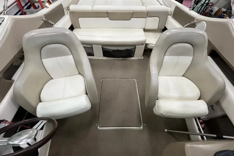 Slide: The Image of Interior of a 2012 Sea Ray SLX 230 boat with white seating and steering wheel. - 14
