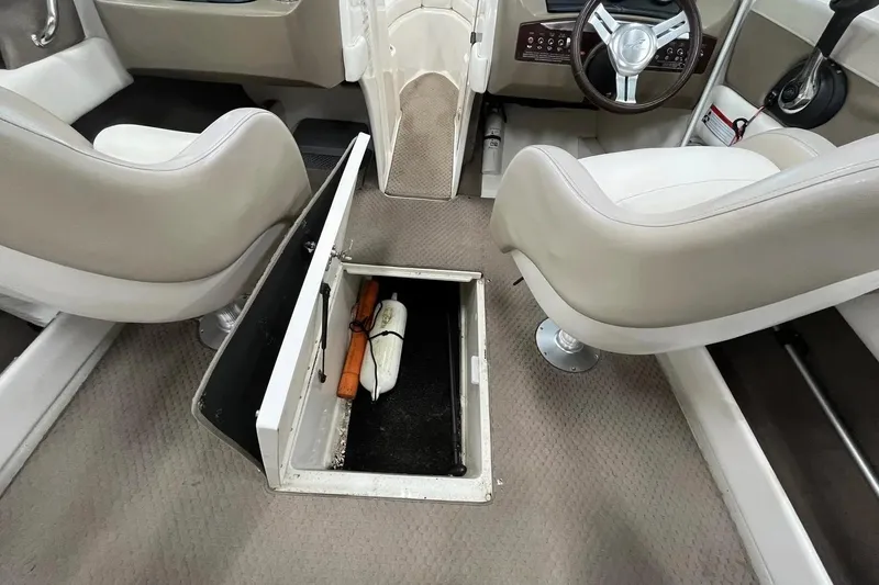Slide: The Image of Interior of 2012 Sea Ray SLX 230 boat with open storage compartment. - 15