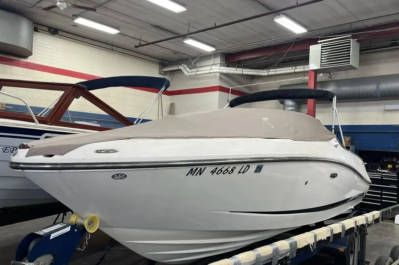 Slide: The Image of 2012 Sea Ray SLX 230 boat in indoor storage, covered and secured. - 17
