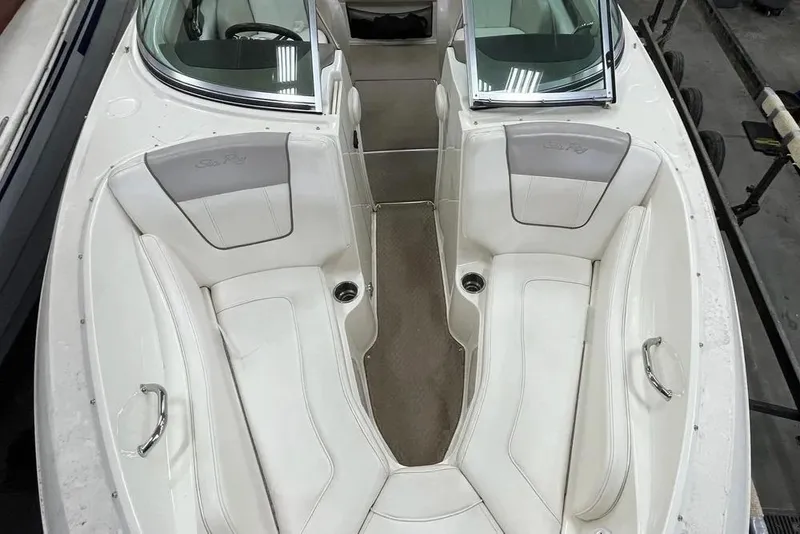 Slide: The Image of 2012 Sea Ray SLX 230 boat interior with white seating and open windshield. - 19