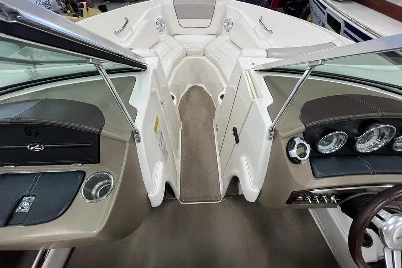 Slide: The Image of Interior view of 2012 Sea Ray SLX 230 boat cockpit with steering and seating area. - 21
