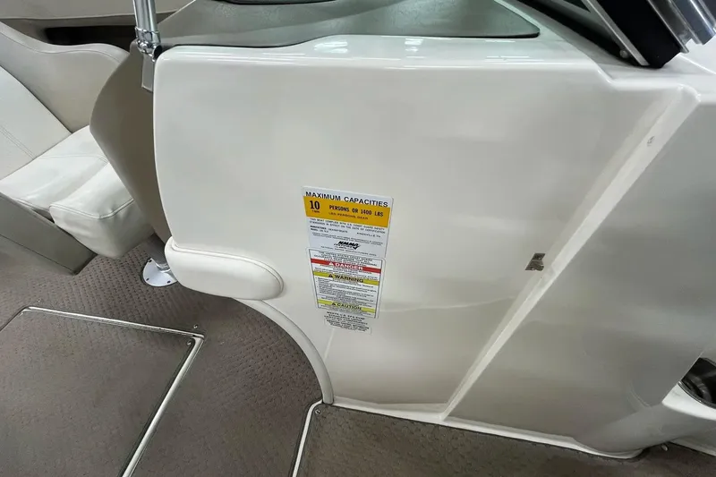 Slide: The Image of 2012 Sea Ray SLX 230 interior showing maximum capacity label and seating area. - 22
