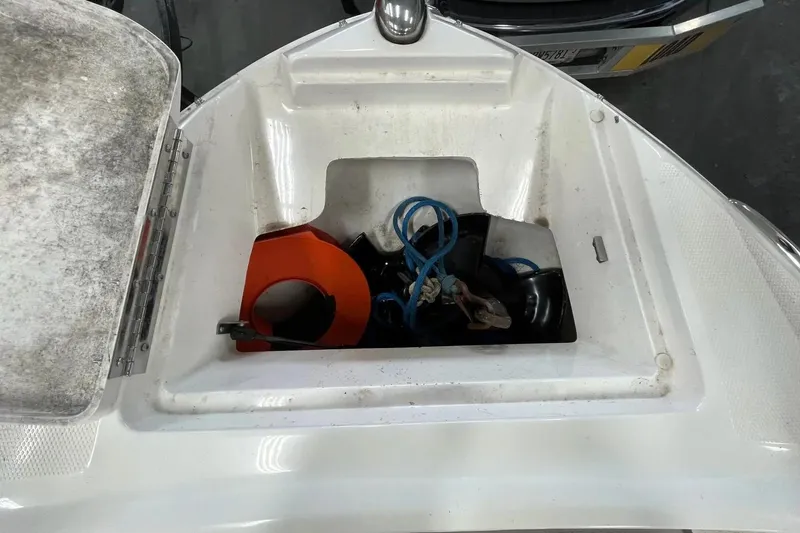 Slide: The Image of Storage compartment of a 2012 Sea Ray SLX 230 boat with ropes and equipment. - 23