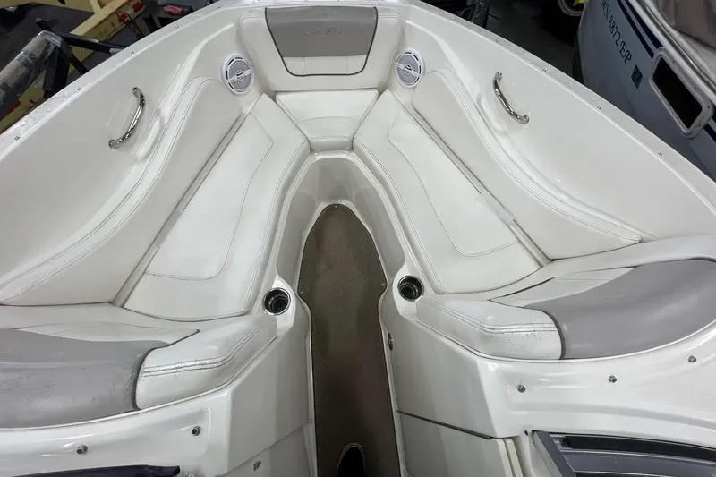 Slide: The Image of Interior view of a 2012 Sea Ray SLX 230 boat with white seating and cup holders. - 25