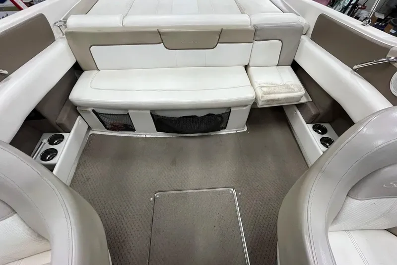 Slide: The Image of Interior of a 2012 Sea Ray SLX 230 boat with beige and white seating. - 26