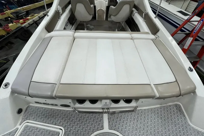 Slide: The Image of 2012 Sea Ray SLX 230 boat interior with beige and white seating. - 28