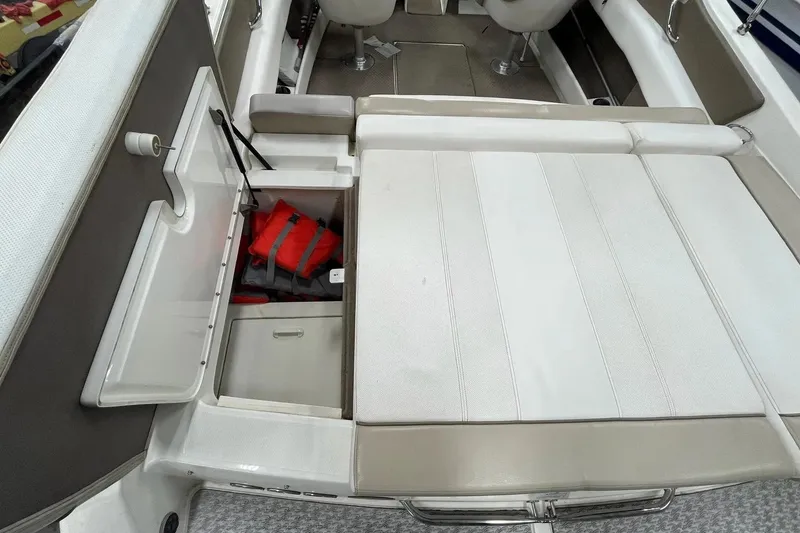 Slide: The Image of Interior of 2012 Sea Ray SLX 230 boat with storage compartment and life jackets. - 30