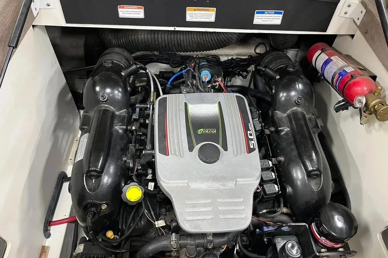 Slide: The Image of Engine compartment of a 2012 Sea Ray SLX 230 boat, featuring a MerCruiser 5.0 MPI engine. - 31
