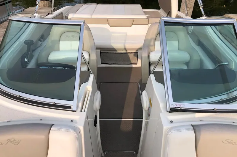 Slide: The Image of 2012 Sea Ray SLX 230 boat interior with dual windshields and plush seating. - 4