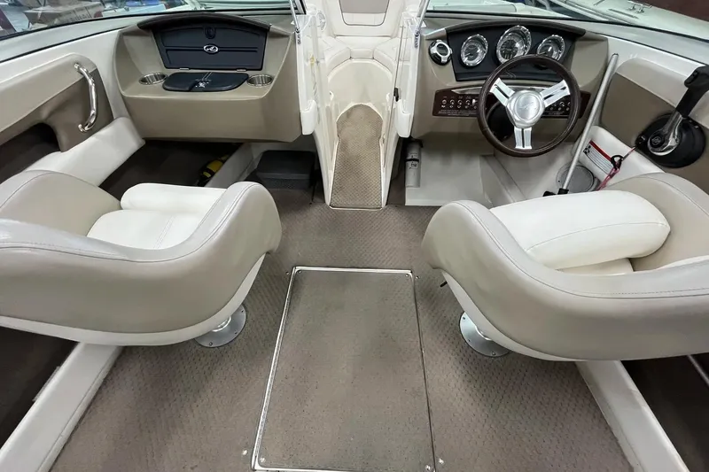 Slide: The Image of Interior of a 2012 Sea Ray SLX 230 boat with beige seating and dashboard. - 5