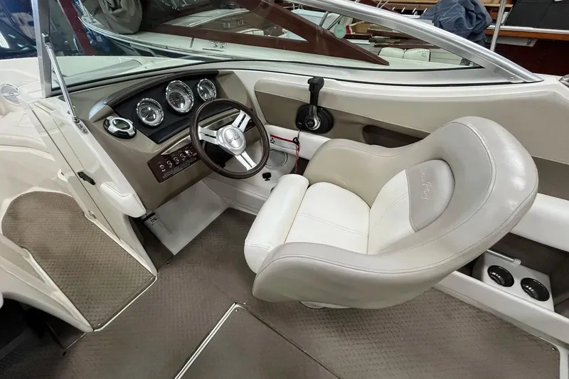 Slide: The Image of Interior of a 2012 Sea Ray SLX 230 boat, featuring a sleek steering wheel and comfortable seating. - 7