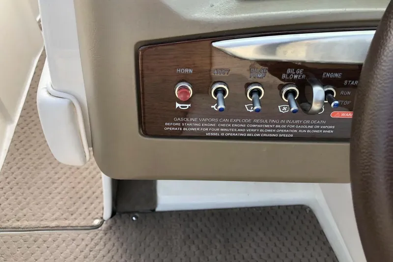 Slide: The Image of Control panel of a 2012 Sea Ray SLX 230 boat with switches and warning label. - 9