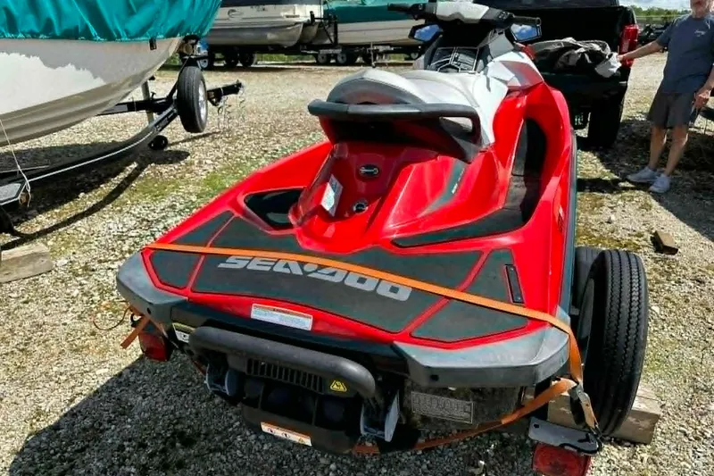 Slide: The Image of 2012 Sea-Doo GTI SE 130 jet ski on trailer, parked outdoors. - 10