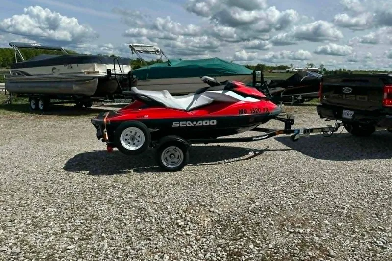 Slide: The Image of 2012 Sea-Doo GTI SE 130 jet ski on trailer, parked on gravel lot. - 5