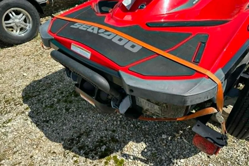Slide: The Image of Red 2012 Sea-Doo GTI SE 130 jet ski secured with orange straps on gravel. - 7