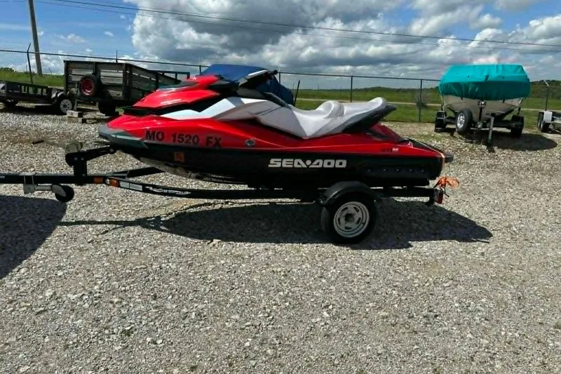 Slide: The Image of 2012 Sea-Doo GTI SE 130 jet ski on trailer, parked outdoors. - 9
