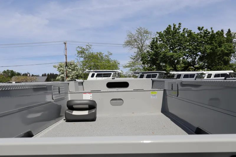 Slide: The Image of 2026 Smoker Craft Sportsman 1866 boat interior with seating, outdoors under clear sky. - 6